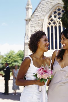 Bride and bridesmaid standing outside church