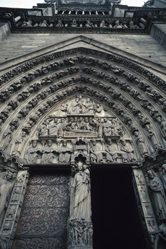 Detailed sculpture decorates the entrance to the Gothic cathedral Notre Dame.