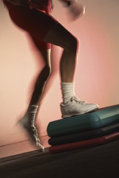 Jupiterimages/Photos.com/Getty Images Step-ups develop three of the major muscles in the legs.
