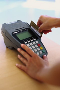 Stockbyte/Stockbyte/Getty Images Using a debit card can help to curb unnecessary spending.