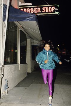 Karl Weatherly/Photodisc/Getty Images Jogging at night can be a stress reliever after a day at work.