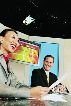 Digital Vision./Digital Vision/Getty Images Working at the anchor desk requires the ability to multi-task.