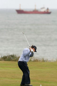 Tom Watson "rings the bell" as he starts down, dropping his right elbow in close to his side as his hips turn toward the target.