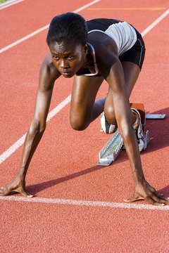 Jupiterimages/Pixland/Getty Images Becoming skilled at using starting blocks is critical for any sprinter.