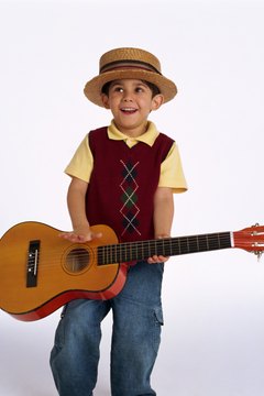 Let your toddler strum a guitar to motivate him to sing along.