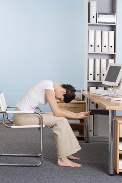 Jupiterimages/Goodshoot/Getty Images Do exercises at your desk to strengthen your back.