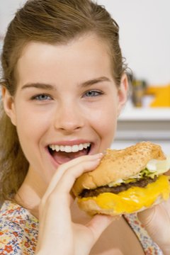 Jupiterimages/Goodshoot/Getty Images Fatty foods increase your cholesterol levels.