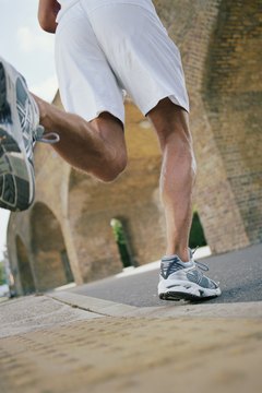 Janie Airey/Digital Vision/Getty Images Running shoes typically feature a stiffer sole, more cushioning and more mesh panels.