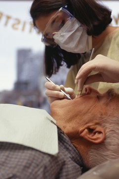 Keith Brofsky/Photodisc/Getty Images Dentists must wear protective goggles, masks and gloves.