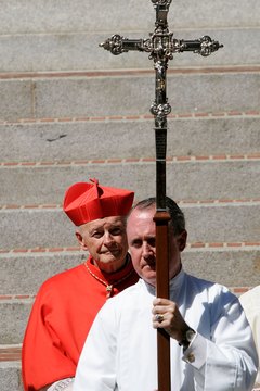 The Catholic archbishop of Washington awaits the arrival of the deceased's body from the vigil site.