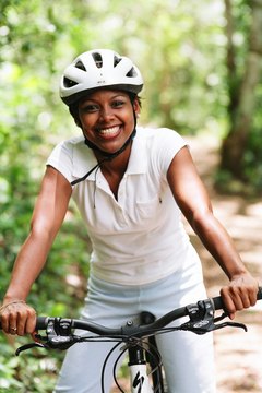 Jupiterimages/Photos.com/Getty Images Riding a bike helps you burn calories faster than walking.