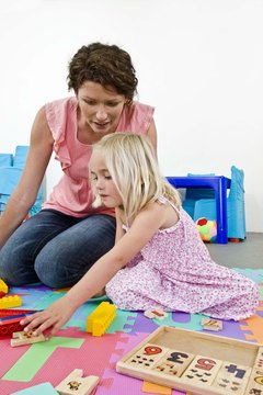 Jupiterimages/Goodshoot/Getty Images Preschool lead teachers have a significant professional role in early child-care education.