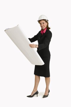 Comstock Images/Comstock/Getty Images An architect spends much of her day in an office setting.