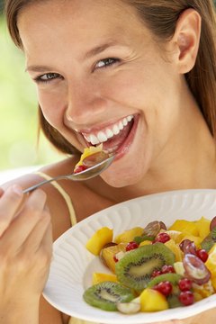 BananaStock/BananaStock/Getty Images Colorful fruits and other nutritious foods boost wellness during menstruation.