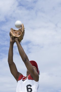 Jupiterimages/Comstock/Getty Images A properly sized glove protects your hand when catching a softball.