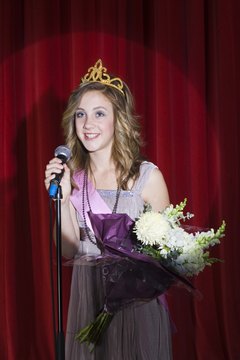 A king and queen pageant will typically award the winner with a crown, sash and a bouquet of flowers.
