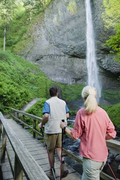 Jupiterimages/Comstock/Getty Images Enjoy Nordic walking alone or with someone else for a social component.