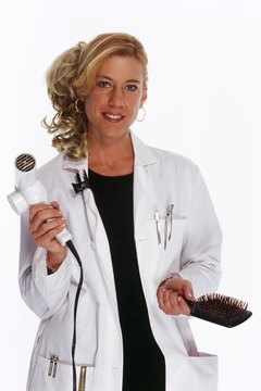 Hairstylist holding hairdryer and brush