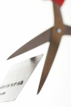 Martin Poole/Photodisc/Getty Images Make paying extra toward your credit card balance part of your monthly budget.