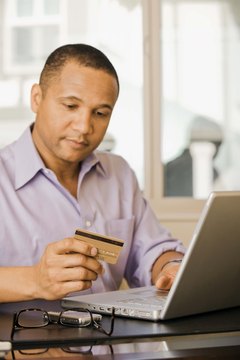 Jupiterimages/Comstock/Getty Images Paying your bills on time is one way to improve your credit score.