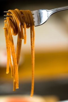 Jupiterimages/Photos.com/Getty Images Whole-grain pasta has more fiber and fewer calories than white pasta.