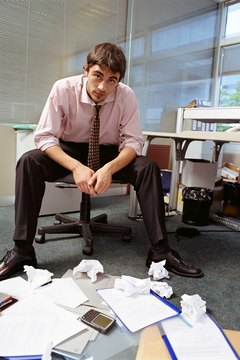 Office worker with pile of papers on floor, Buenos Aires, Argentina