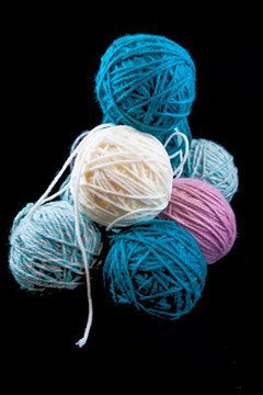 Make buttons using yarn, paint and a paper plate.