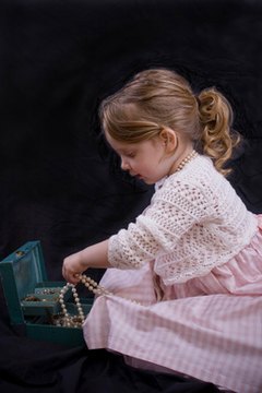 Little girl playing dress up