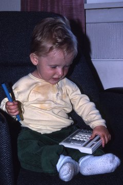 Little boy playing with a calculator