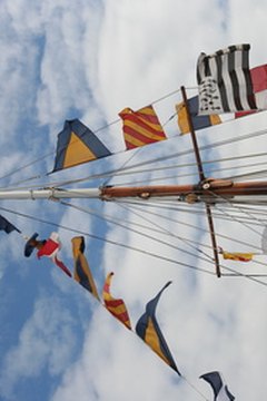 An array of signal flags dress the rigging of this ship.