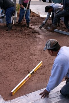 Level the ground and pour a concrete floor.