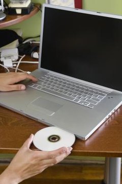 Inserting a CD-ROM into a laptop computer