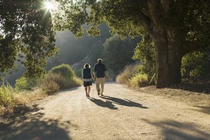 Mature couple walking down dirt road