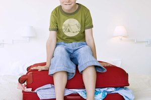 Boy sitting on suitcase