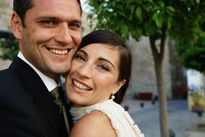 Bride and groom embracing, smiling, portrait, close-up