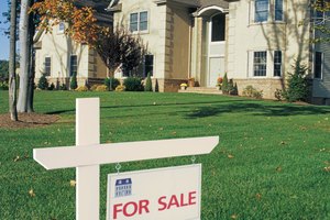 For sale sign in front of house