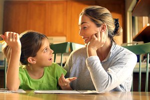 Mother helping daughter with homework