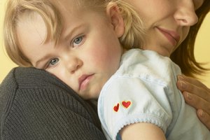 Mother soothing tired girl