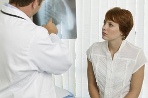 Doctor and patient examining x-ray