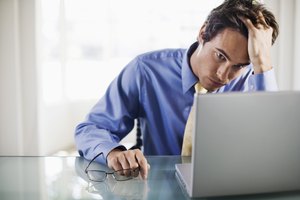 Frustrated businessman with laptop computer