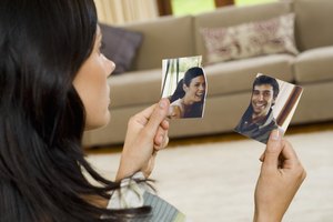 Woman with torn photograph of couple