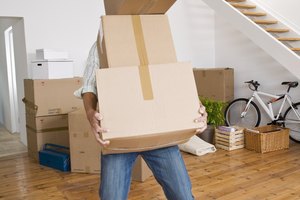 Man carrying heavy moving boxes