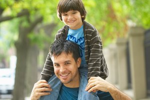 Father posing with son on his shoulders