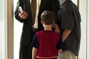 Father with sons and cell phone in doorway