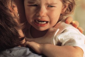 Baby crying on mother's shoulder