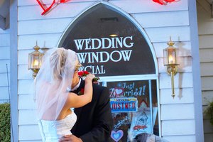 Couple hugging at drive up wedding chapel