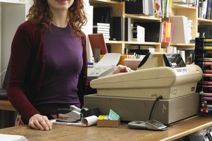 Female shop assistant by cash register in art shop, smiling, portrait