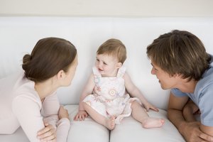 Parents with baby on couch