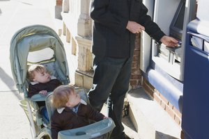 Father with twins at an ATM