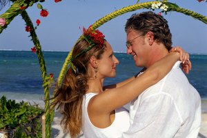Couple embracing at beach wedding